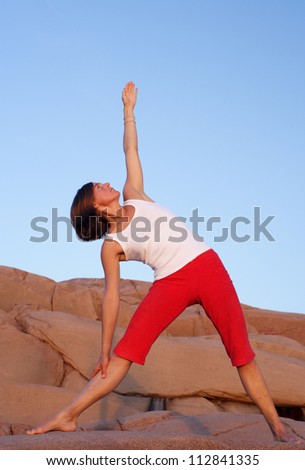 A woman doing yoga by the sea, Sweden.