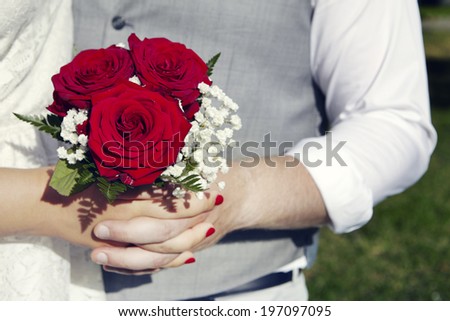 Close-up of hands holding wedding bouquet, Uppsala, Sweden