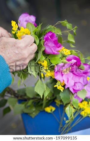Hands holding flowers, Nykoping, Sodermanland, Sweden