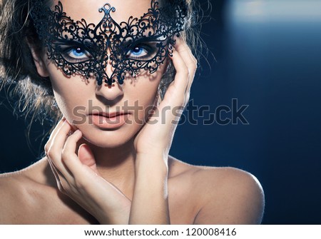 Mask.Nude.Girl.Venice carnival mask Close-up female portrait.Blue eyes. Black background