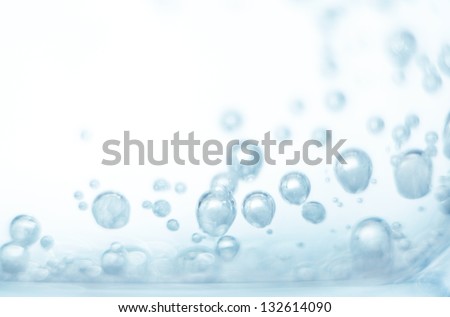 Bubbles of oxygen in glass of water on a blue background. Mineral water. Water enriched with oxygen.Oxygen. Water.Water background. Macro.Texture.Glass with water.Natural.Background.Neutral background