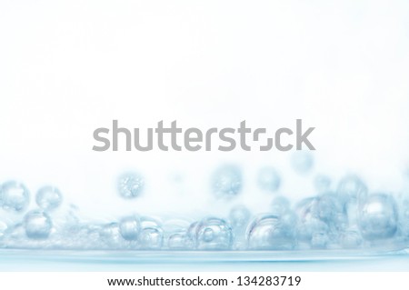Bubbles of oxygen in glass of water on a white background. Mineral water. Water enriched with oxygen.Oxygen. Water.Water background. Macro.Texture.Glass with water.Natural.