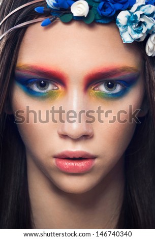 Close-up of beautiful female face with colorful make-up.Beauty. Fresh glowing skin. Accessory.Flower.Blue.Art.Theater.Face art.Bright.Closeup.Portrait.Look\
Fashion make-upt.Fantastic Modern production