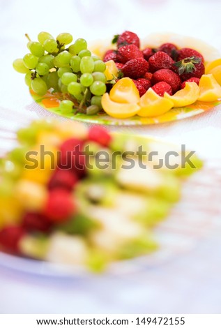 Healthy fresh fruits in a plate .Mixed fruits  on skewers isolated on white background