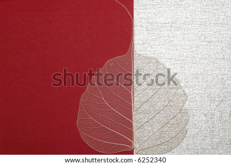 aged leaf over red-silver background