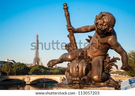Sculpture of Child on the bridge of Alexander III in the morning, with the Eiffel Tower in the background