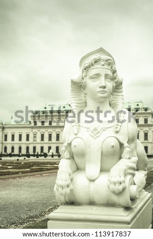 Statue of naked woman with a lion body (sphinx) in front of the Belvedere palace in Vienna, austria