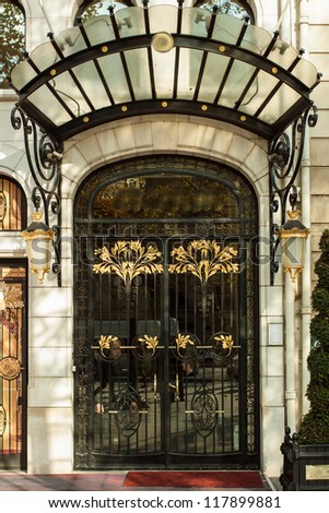 Decorated door of a luxurious hotel in paris