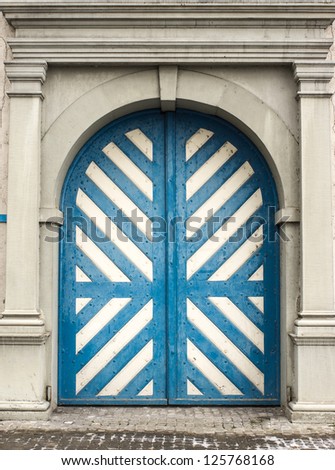 Old door with blue and white strip in Lucerne, Swiss