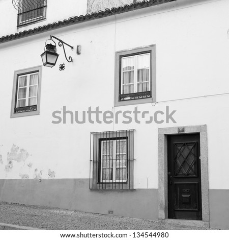 Door, Windows and Streetlamp in a simple style on the street of Evora, Portugal