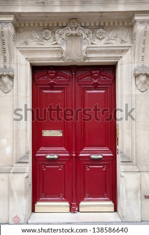 Red old wooden door in Paris, France