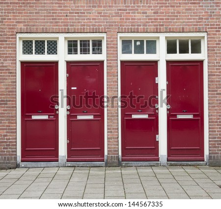 Simple red wooden doors in Amsterdam, Netherlands