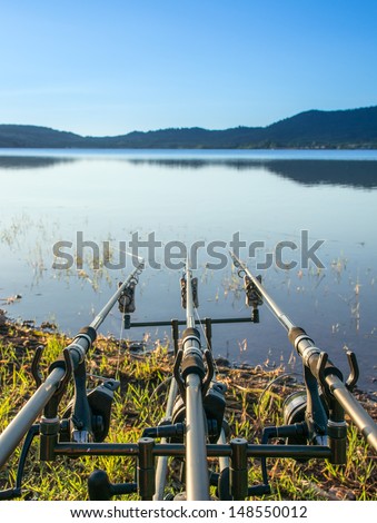Three parallel fishing rod at dawn, the Salagou Lake, Herault, France