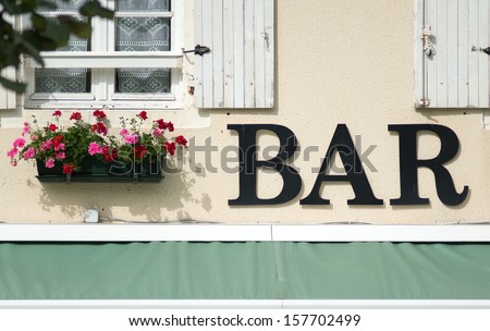 Bar sign by geraniums, vezelay, burgundy, France