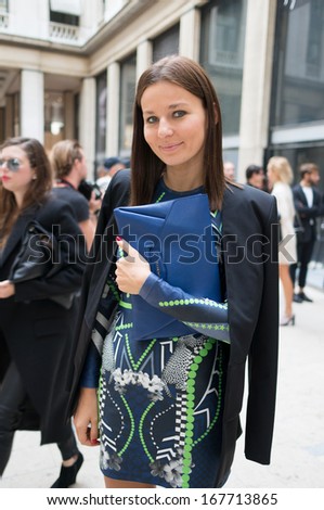 PARIS - OCTOBER 2: Stylish woman during the Paris Fashion Week on October 2, 2013 in Paris, France. Paris Fashion Week is a clothing trade show held semi-annually each year in Paris, France.