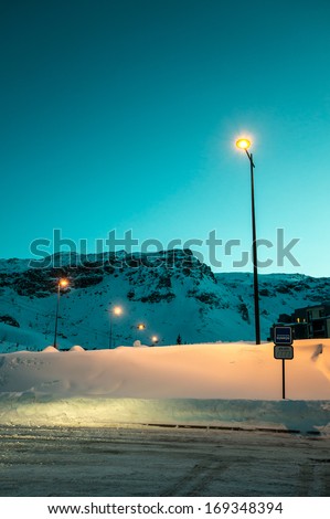 Night bus station in the snow covered mountain at Tigne, Savoie, France