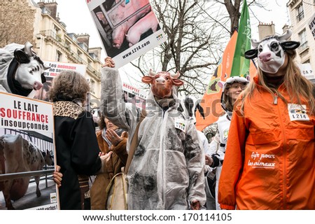 PARIS - JANUARY 7, 2014: People with cow mask protest against the farm-factory near the National Assembly. The farm-factory is condemned by the protestors because of infringement of animal rights.
