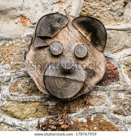 Wooden pig head on a stone wall