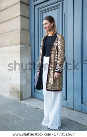 PARIS - FEBRUARY 26, 2014: Stylish European woman with sparkling coat at the Place Vendome. Paris Fashion Week: Ready to Wear 2014/2015 is held in Paris from February 25 to March 5, 2014.