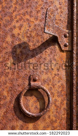 Knocker on a rusty metal door, Oradour sur Glane, France.  In this village, 642 of its inhabitants were massacred by a German Waffen-SS company in the second world war.