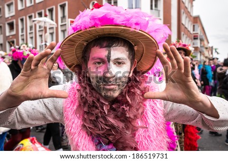 DUNKIRK, FRANCE - MARCH 2, 2014: Man with face painting and straw hat on the street. Dunkirk holds the biggest and most popular carnival in northern France.