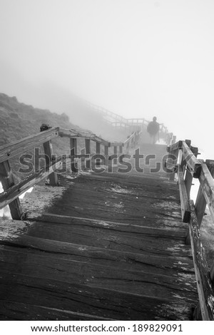 Wooden staircase on the foggy mountain of Puy de Sancy, Auvergne, France