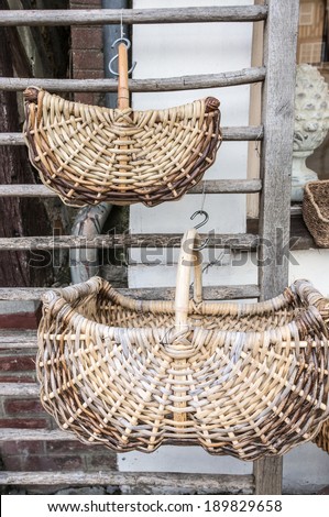 Wicker baskets on sale in front of a shop, Beuvron en Auge, Normandy, France