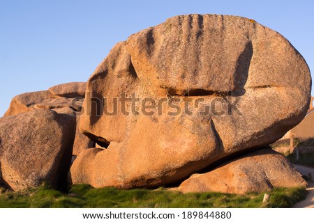 Granite rock of Human head shape on the pink granite coast, Ploummanac, Brittany, France