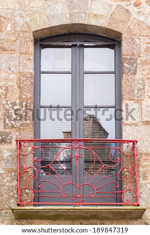 Beautiful balcony with red metal bannister