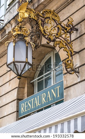Restaurant sign with luxurious lamp in Nancy, France