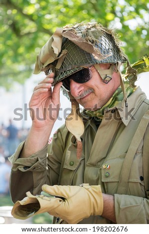 SAINTE-MERE-EGLISE, FRANCE - JUNE 6, 2014: Man in military uniform of the Second World War during the commemoration of the 70th anniversary of D-Day.