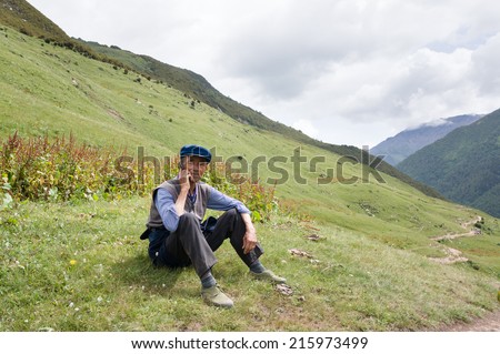 SICHUAN, CHINA - AUGUST 5, 2014: Old Tibetan calls with a mobile phone. Many Tibetans live in the western Sichuan.
