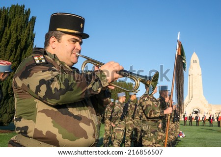 VERDUN, FRANCE - NOVEMBER 11, 2013: A soldier plays bugle in the ceremony of Armistice Day at Douaumont Ossuary near Verdun, France. The year of 2014 is the centennial of the first world war.