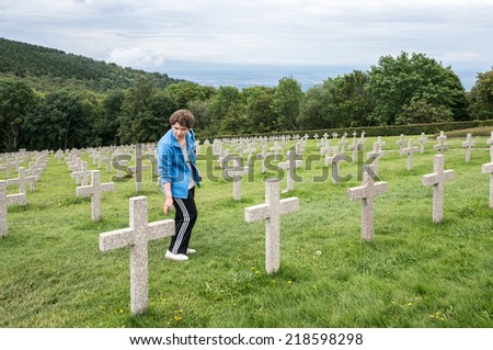 HARTMANNSWILLERKOPF, FRANCE - AUGUST 29, 2014: A visitor in the military graveyard of heroes in the First World War. The French and Germans fought for control of this place in the First World War.