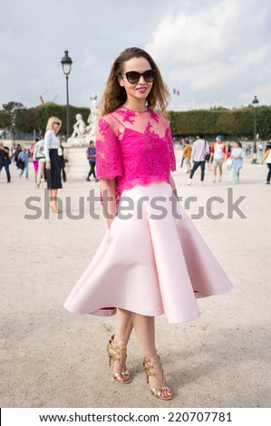 PARIS - SEPTEMBER 30, 2014: Stylish european woman with pink dress in the Tuileries Garden. Paris Fashion Week: Ready to Wear 2014/2015 is held from September 23 to October 1, 2014.