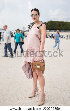 PARIS - SEPTEMBER 30, 2014: Stylish european woman with Prada bag in the Tuileries Garden. Paris Fashion Week: Ready to Wear 2014/2015 is held from September 23 to October 1, 2014.