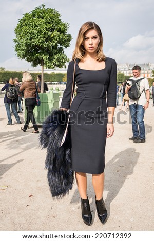 PARIS - SEPTEMBER 30, 2014: Stylish european woman with black skirt in the Tuileries Garden. Paris Fashion Week: Ready to Wear 2014/2015 is held from September 23 to October 1, 2014.