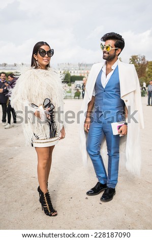 PARIS - SEPTEMBER 30, 2014: Stylish european woman and man with fantastic sunglasses in the Tuileries Garden. Paris Fashion Week: Ready to Wear 2014/2015 is held from September 23 to October 1, 2014.