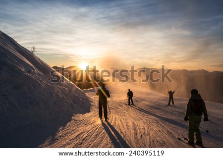 Skiers on the piste at dusk, Les Arcs, Bourg Saint Maurice, Savoie, France