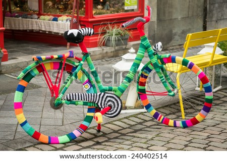 AACHEN, GERMANY - DECEMBER 6, 2014: A bicycle covered by colorful pullovers in front of a shop. Aachen is a city with population of 260,000 in North Rhine-Westphalia.