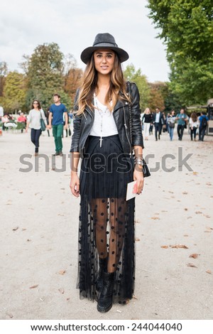 PARIS - MARS 5, 2013: Stylish European woman with black leather jacket in the Tuileries Garden. Paris Fashion Week: Ready to Wear 2013/2014 is held from February 26 to March 6, 2013.