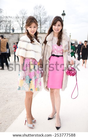 PARIS - MARS 5, 2013:  Two Stylish Asian women with pink skirt in the Tuileries Garden. Paris Fashion Week: Ready to Wear 2013/2014 is held from February 26 to March 6, 2013.