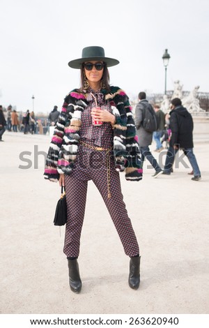 PARIS, FRANCE - MARCH 7, 2015: Stylish European woman with colorful leather jacket in the Tuileries Garden. Paris Fashion Week: Ready to Wear 2015/2016 is held from March 3 to 11, 2015.