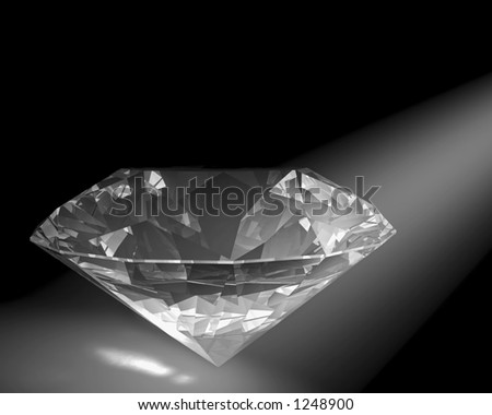 A diamond sparkles in a white spot light.