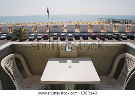 Table for two on balcony overlooking resort beach at Ostia, Italy