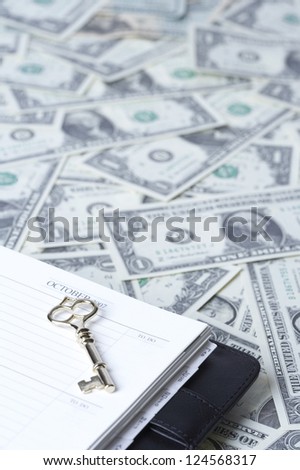 Diary with key on US paper currency note