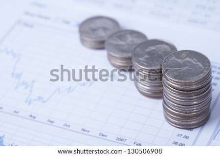 Stacks of coins on financial paper, close up