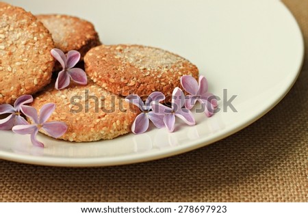 fresh home baked oatmeal cookies on plate with flowers for breakfast