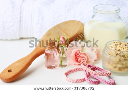 Hair care domestic treatment herbal, rose, oat flakes, milk in cosmetic jars, bathroom towel