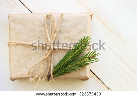 New year gift box handicraft wrapping, parchment twine fir tree twigs, cute simple last minute present handmade